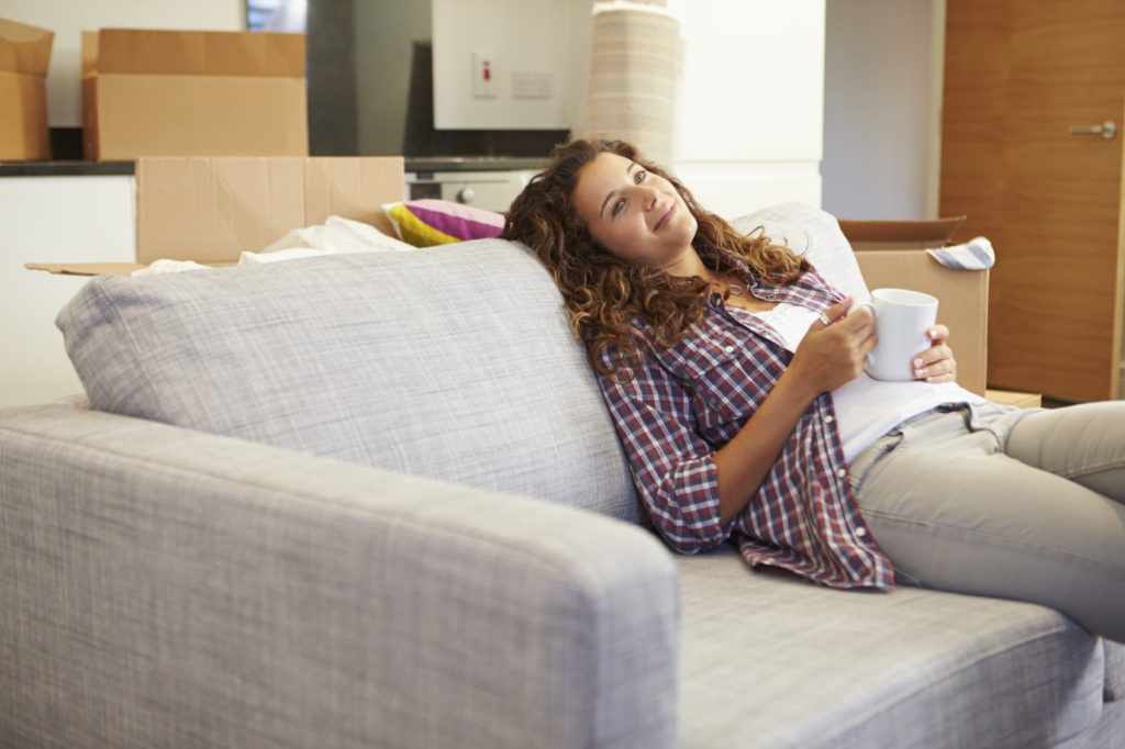 Woman relaxing on couch with coffee