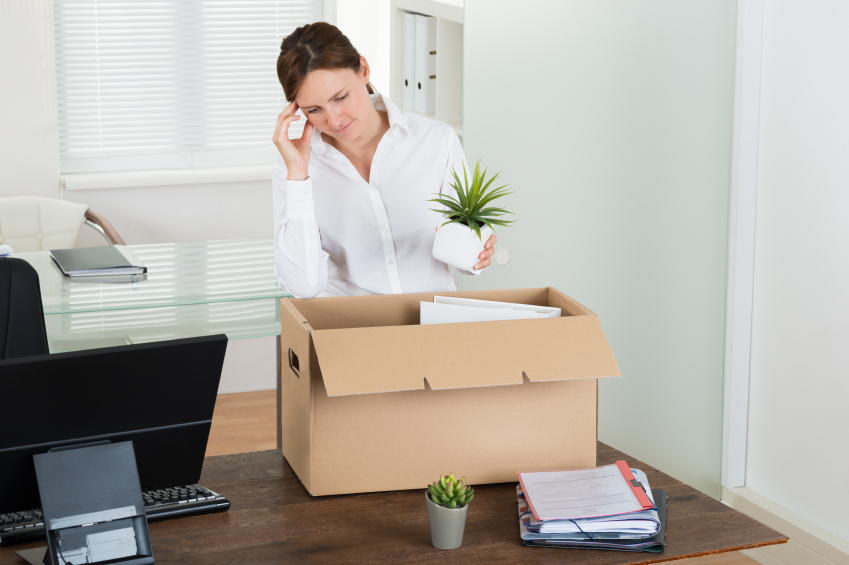 Woman making very difficult decision about whether to put her desk plant into the box she was given since HR gave her the can five minutes ago or throw it at Todd cause man that guy has some issues